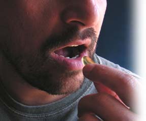 man taking natural semen pill